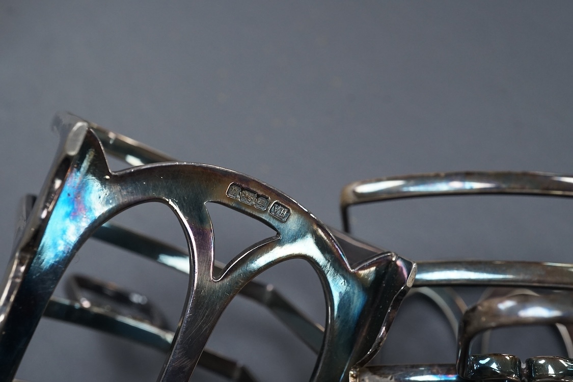 A pair of George V silver five bar toast racks, by Atkin Brothers, Sheffield, 1912, length 94mm, together with a silver muffin dish lid and a silver pedestal bonbon dish, 26.2ox